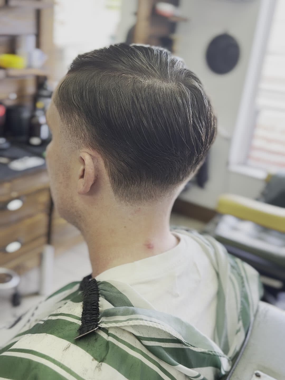 Classic side part with a clean taper, fresh from the chair